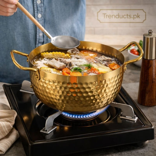 Golden stainless steel cookware pot on gas stove