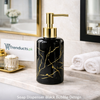 Polished glossy black marble design soap dispenser with white veining and a silver chrome pump - Trenducts Pakistan