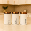 Three minimalist matte white kitchen storage jars with copper lids labeled Tea, Coffee, and Sugar - Trenducts Pakistan