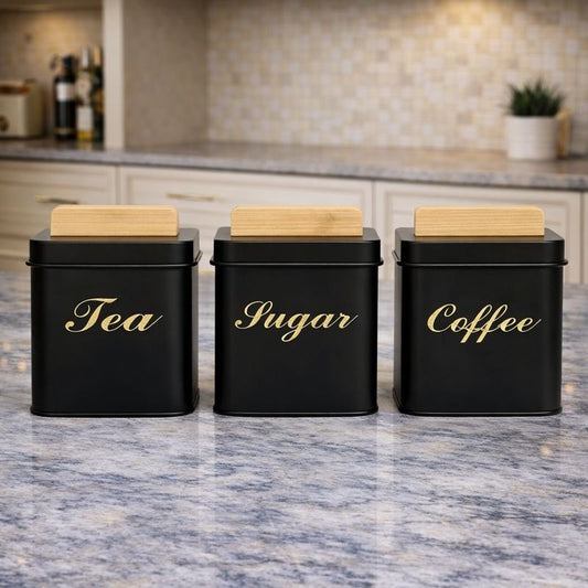 Three square matte black metal kitchen jars with light wood bamboo lids labeled Tea, Coffee, and Sugar - Trenducts Pakistan