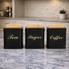 Three square matte black metal kitchen jars with light wood bamboo lids labeled Tea, Coffee, and Sugar - Trenducts Pakistan