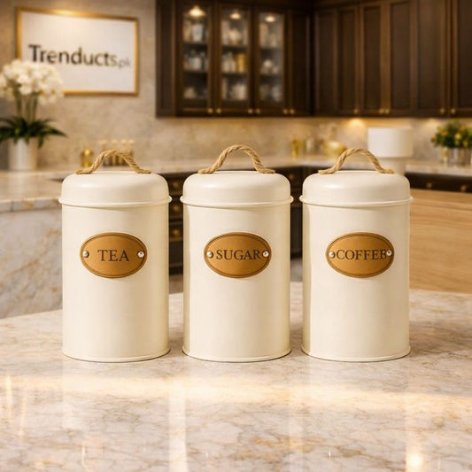 Three off-white metal kitchen canisters with natural rope handles and leather-look labels for Tea, Sugar, and Coffee - Trenducts Pakistan