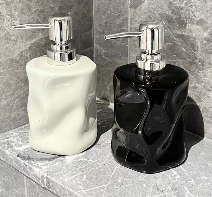 Sculptural twisted design soap dispenser in obsidian black and arctic white with silver pumps - Trenducts Pakistan