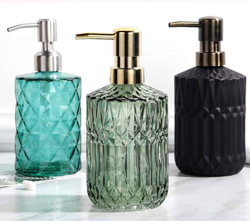 Emerald green and sapphire blue ribbed glass soap dispensers with gold and silver pumps on a bathroom vanity - Trenducts Pakistan