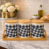 Three checkered ceramic jars for tea, coffee, and sugar with bamboo lids sitting on a bamboo tray on a kitchen counter - Trenducts Pakistan