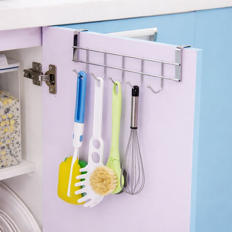 Stainless steel 5-hook rack hanging over a purple cabinet door holding kitchen utensils